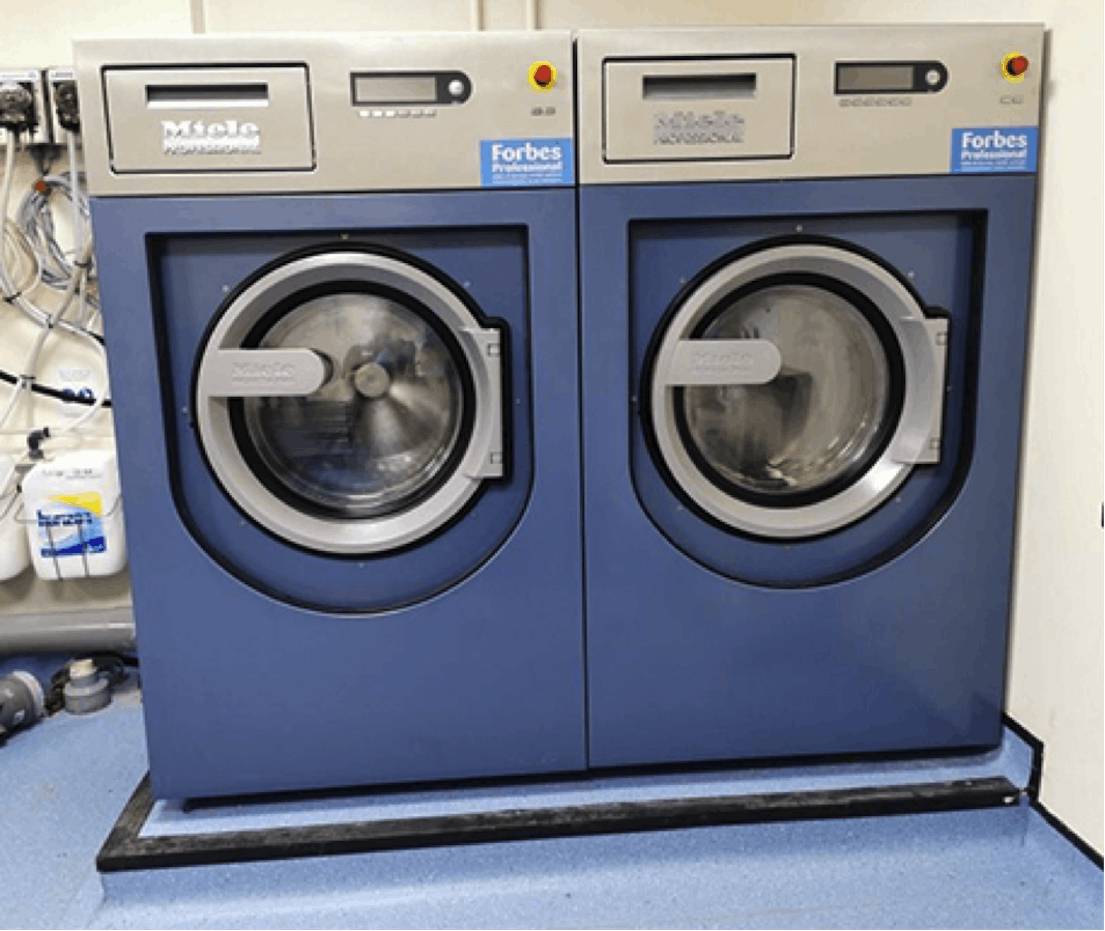 Two blue Miele's 13kg PW413 commercial machines in NHS premise
